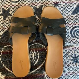 tan and black slip on sandals
